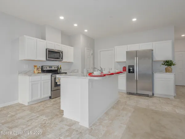 a kitchen with refrigerator cabinets and microwave