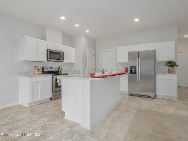 a kitchen with refrigerator cabinets and microwave