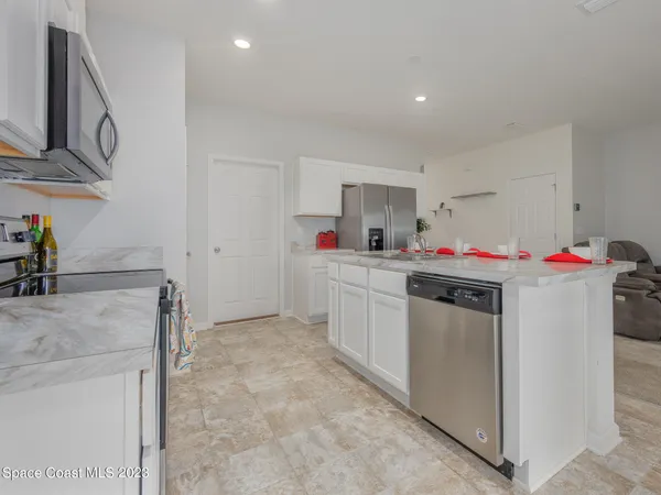 a utility room with cabinets washer and dryer