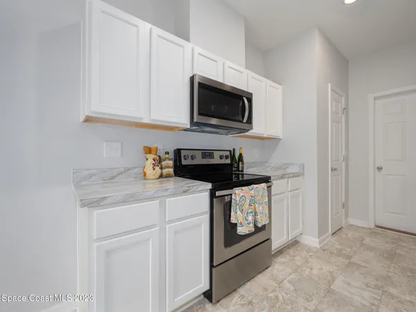 a kitchen with stainless steel appliances granite countertop a sink and a microwave
