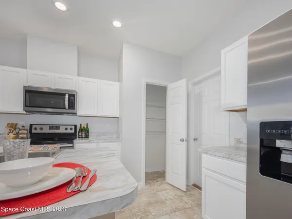 a living room with furniture and kitchen view