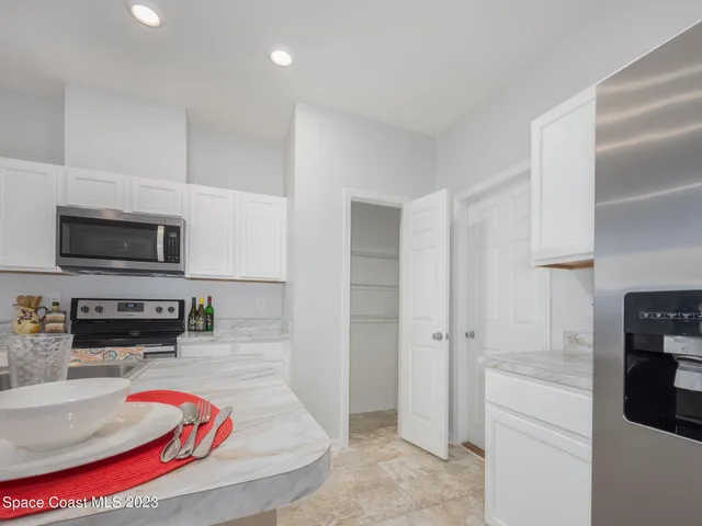 a living room with furniture and kitchen view