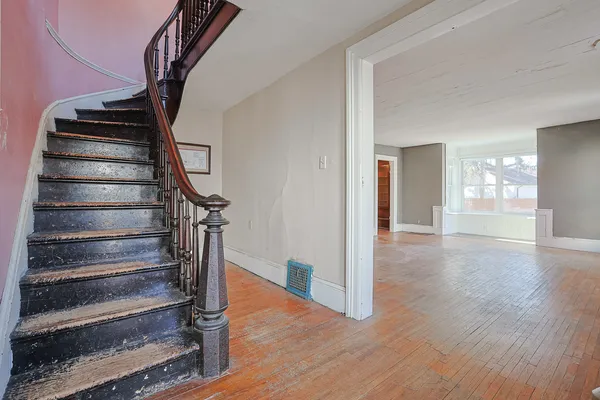 a view of entryway and hall with wooden floor