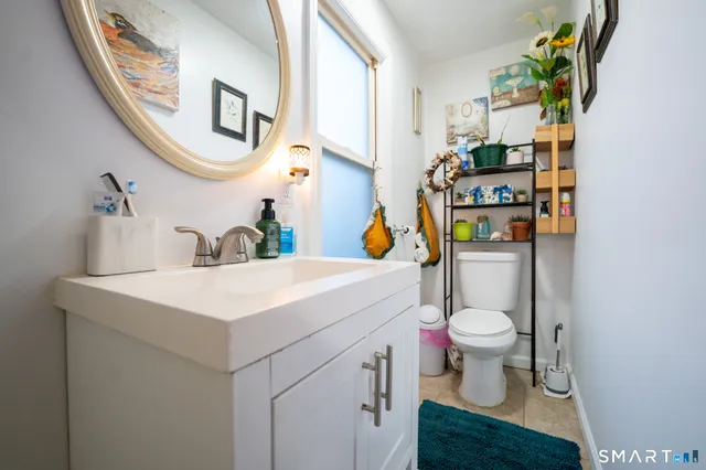 a bathroom with a sink toilet and mirror