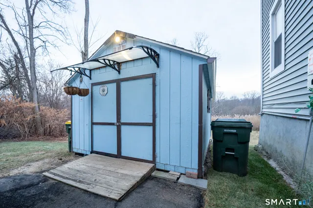 a view of a house with a small yard and wooden fence