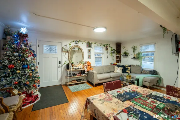 a living room with furniture and flowers
