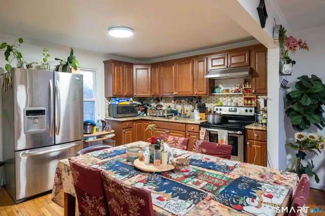 a kitchen with stainless steel appliances granite countertop a refrigerator sink and stove