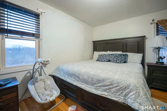 a bedroom with a bed and window