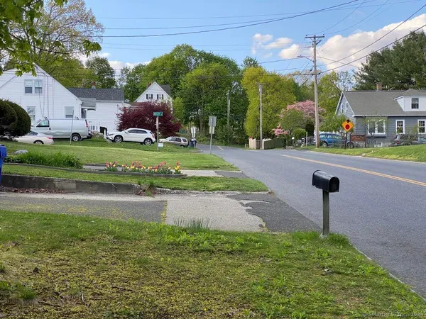 a front view of a house with a garden and street view