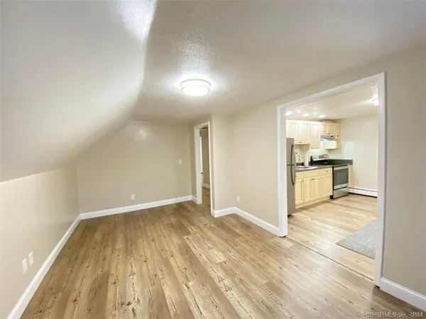 a view of a kitchen with wooden floor and a kitchen