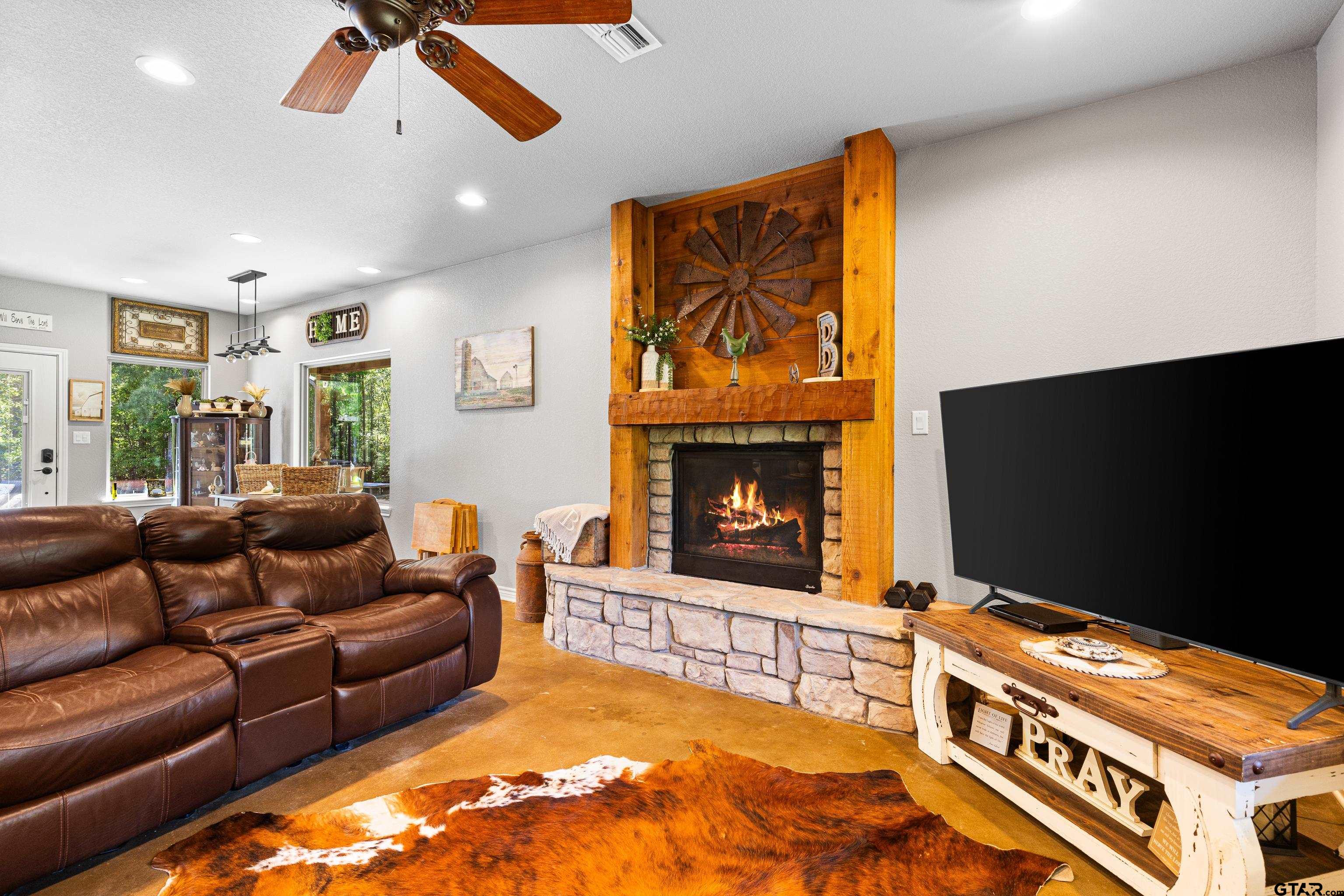 10586 Petunia Road Ore City, TX 75683 - Photo 12 of 45 a living room with furniture and a flat screen tv