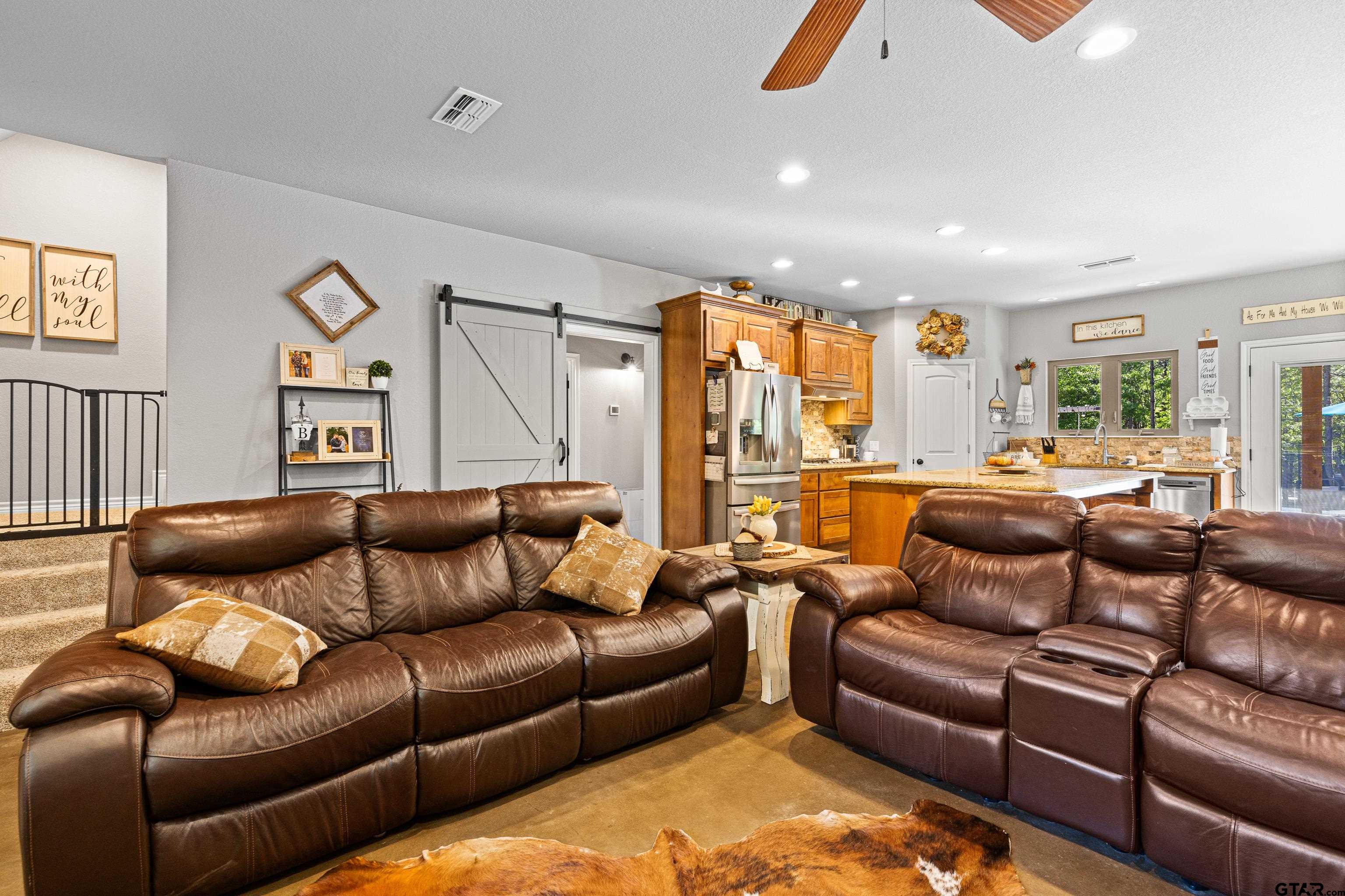 10586 Petunia Road Ore City, TX 75683 - Photo 14 of 45 a living room with furniture ceiling fan and a rug