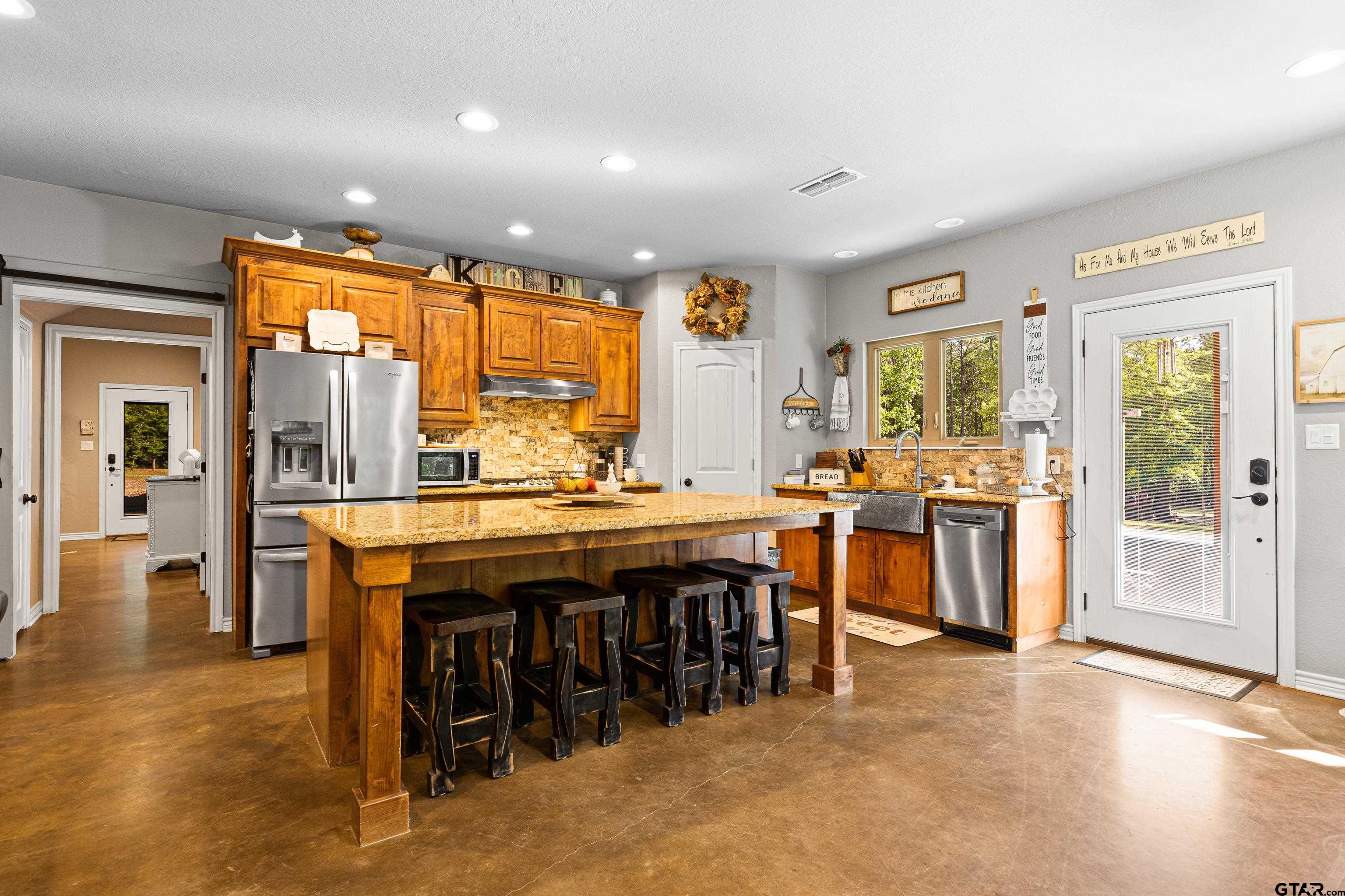 10586 Petunia Road Ore City, TX 75683 - Photo 15 of 45 a dining hall with stainless steel appliances granite countertop a stove and a refrigerator