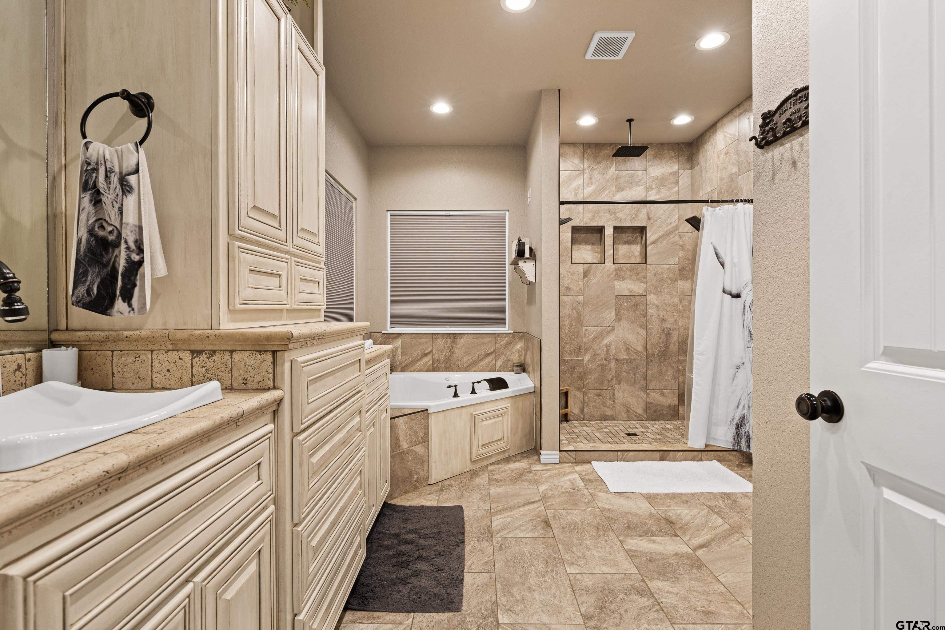 10586 Petunia Road Ore City, TX 75683 - Photo 27 of 45 a bathroom with a sink a toilet a mirror and shower