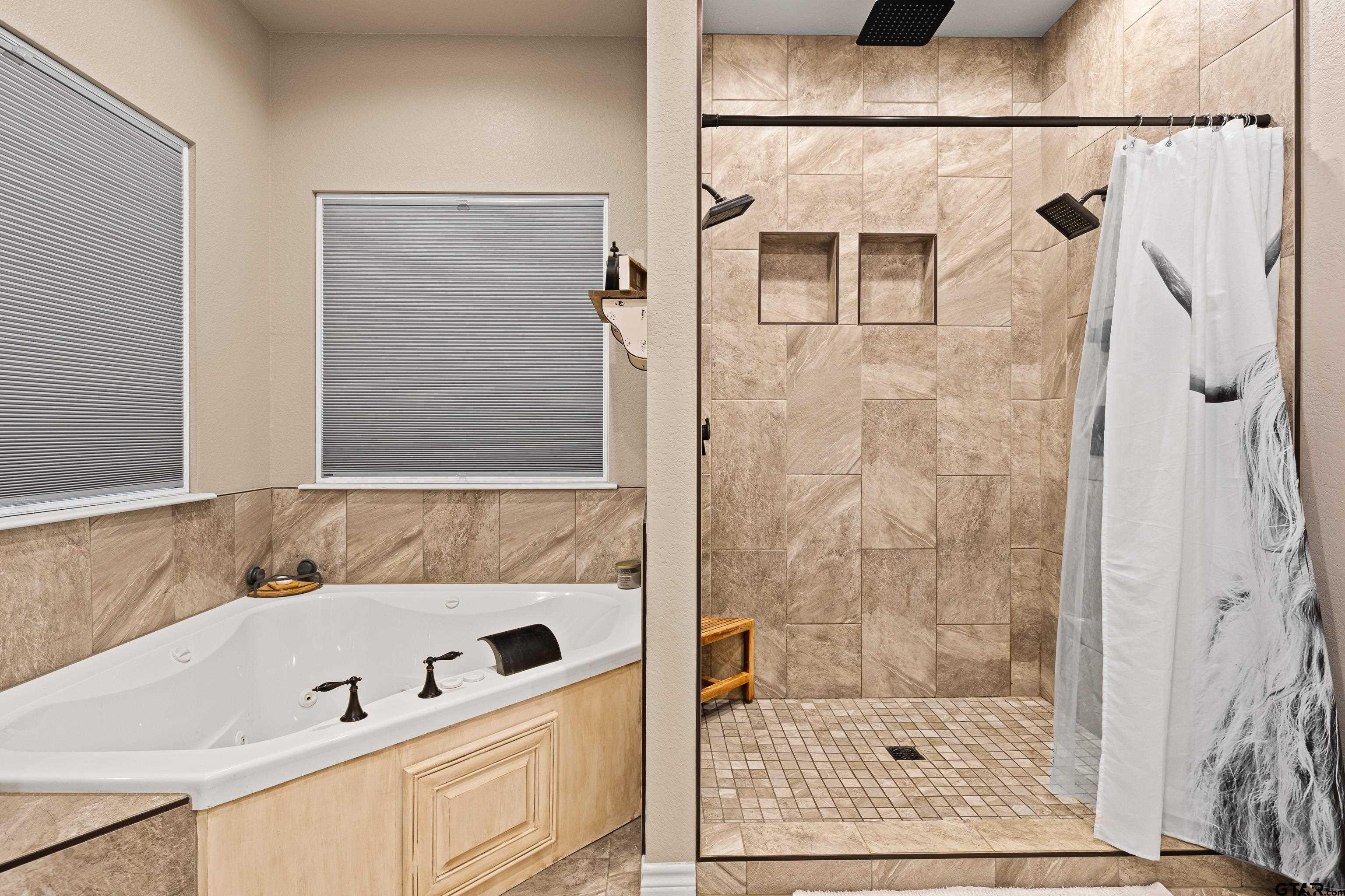 10586 Petunia Road Ore City, TX 75683 - Photo 28 of 45 a bathroom with a bathtub and a shower