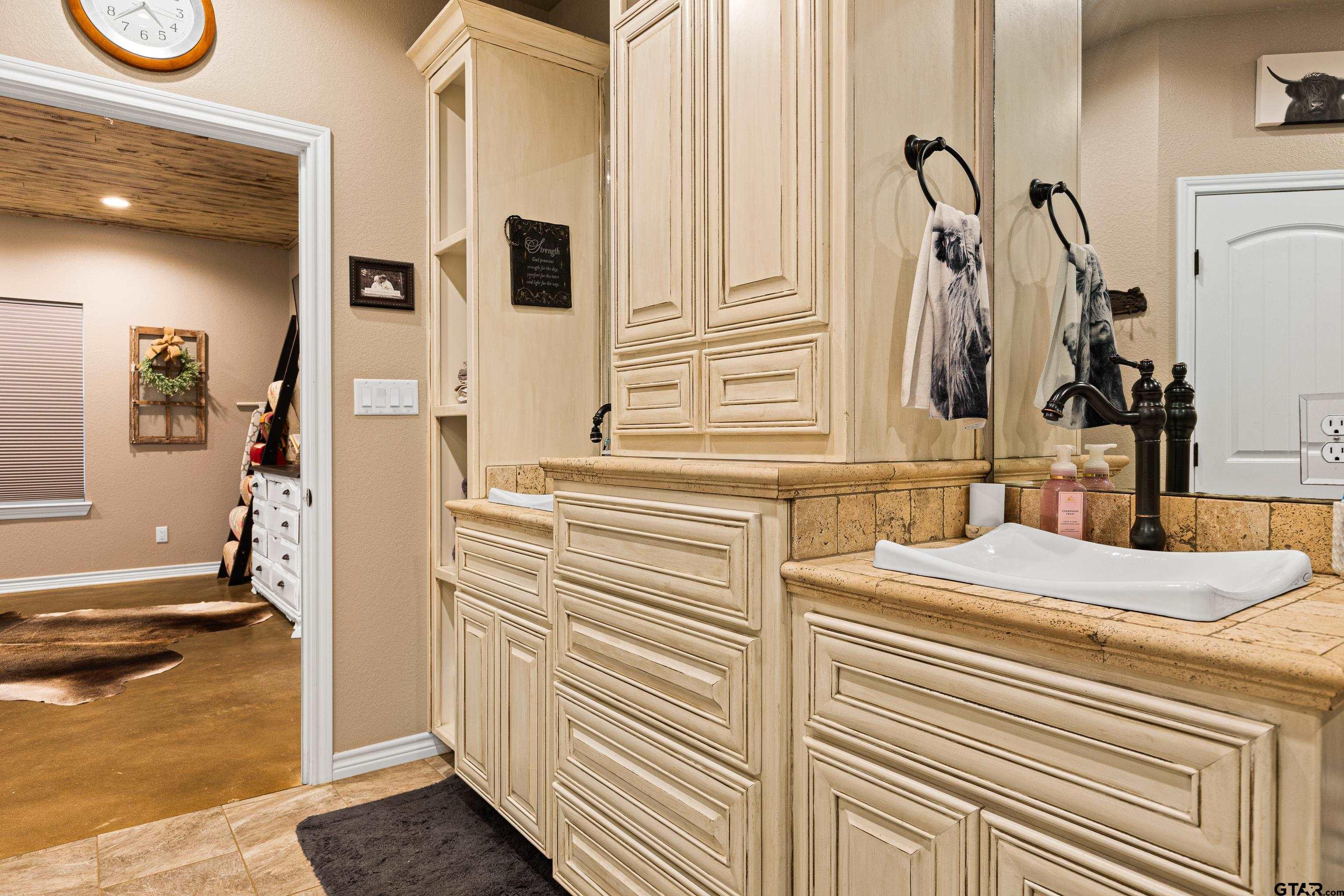 10586 Petunia Road Ore City, TX 75683 - Photo 29 of 45 a bathroom with a sink and a mirror