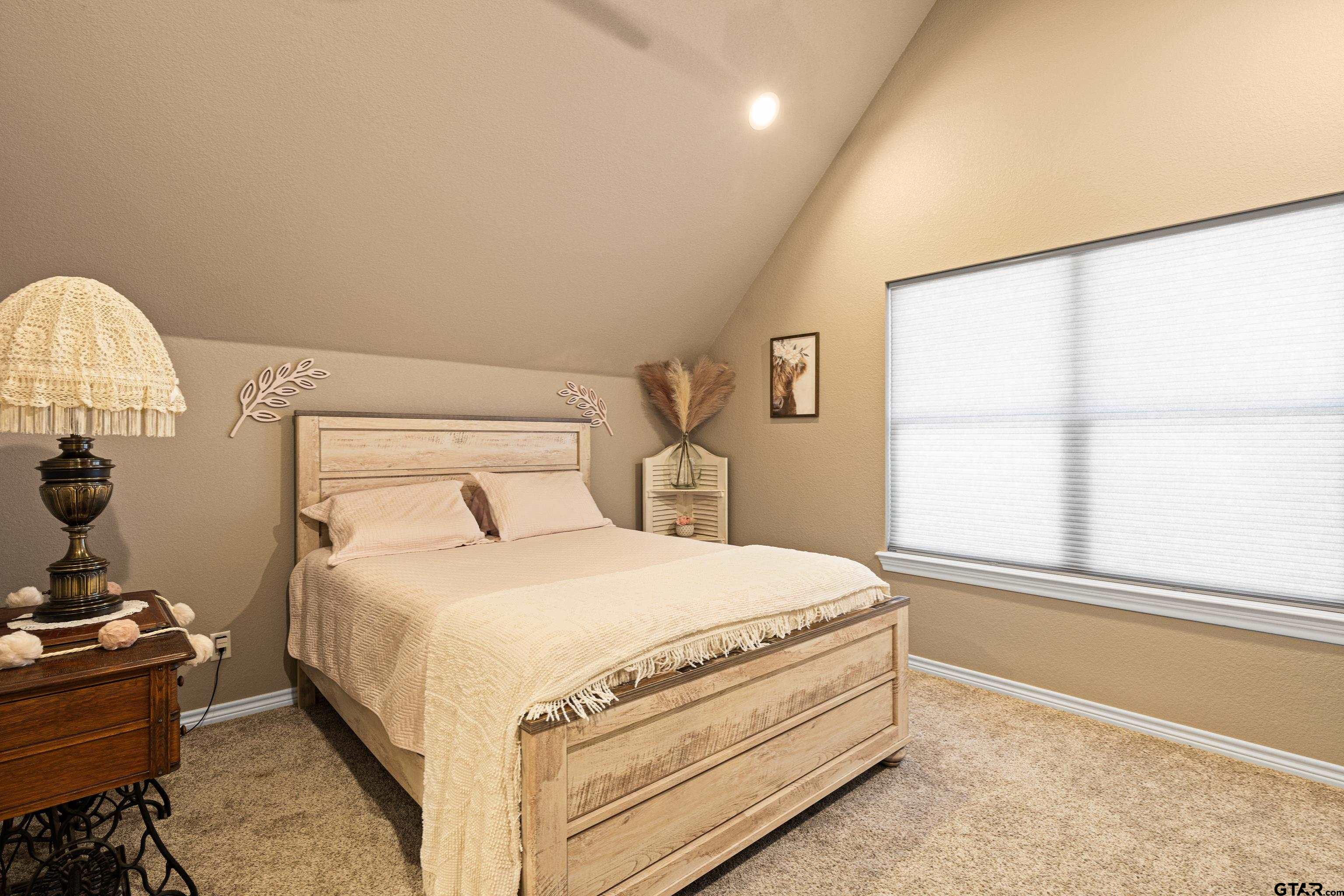 10586 Petunia Road Ore City, TX 75683 - Photo 31 of 45 a bedroom with a bed and a window