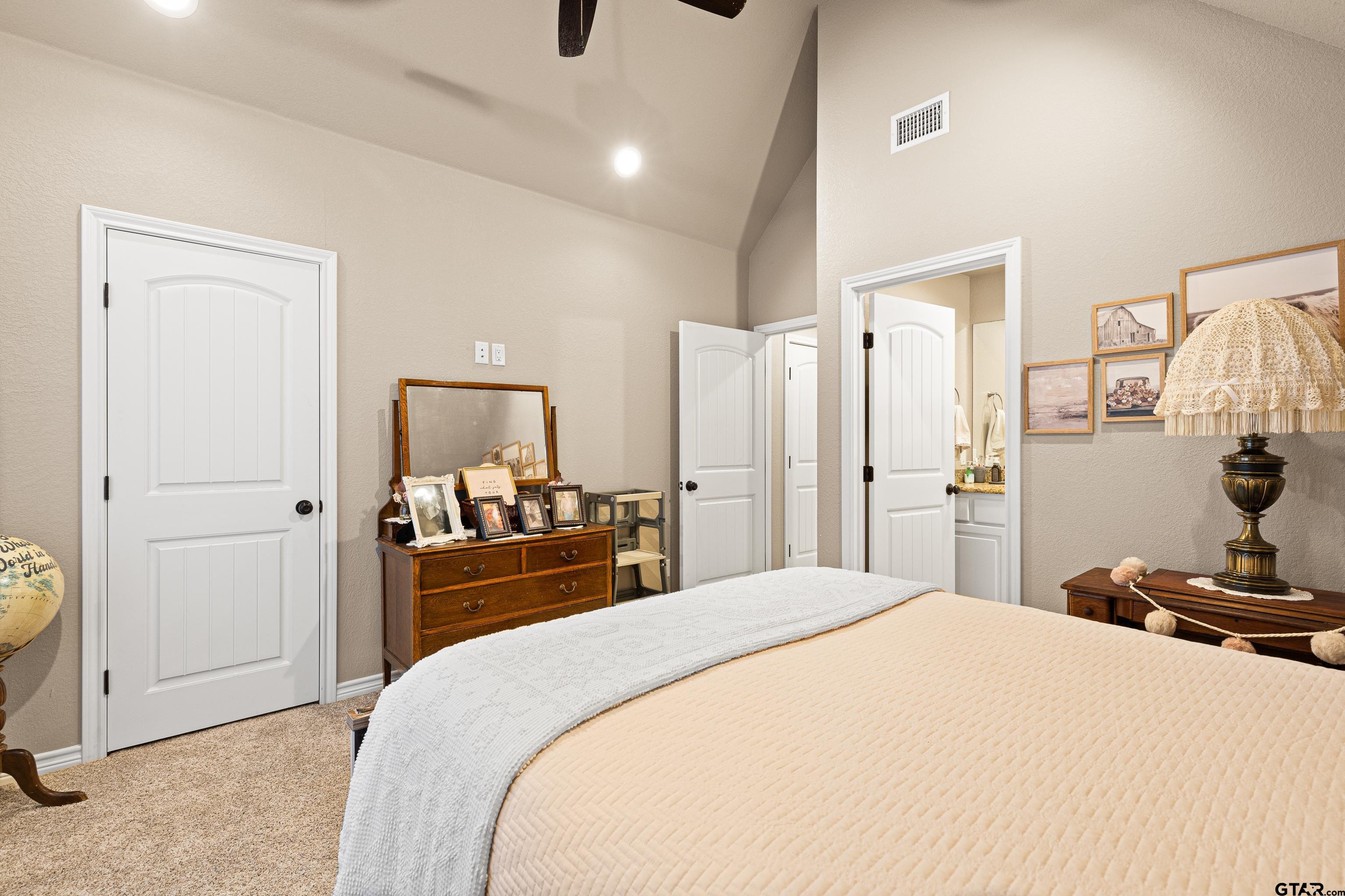 10586 Petunia Road Ore City, TX 75683 - Photo 32 of 45 a bedroom with a bed and a large mirror