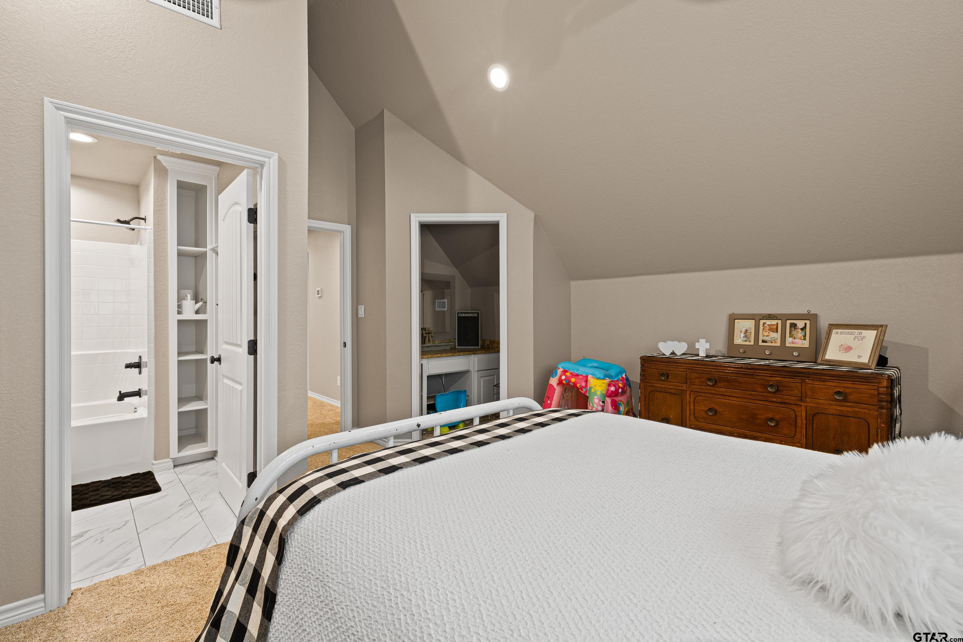 10586 Petunia Road Ore City, TX 75683 - Photo 35 of 45 a bed room with a bed and a large mirror