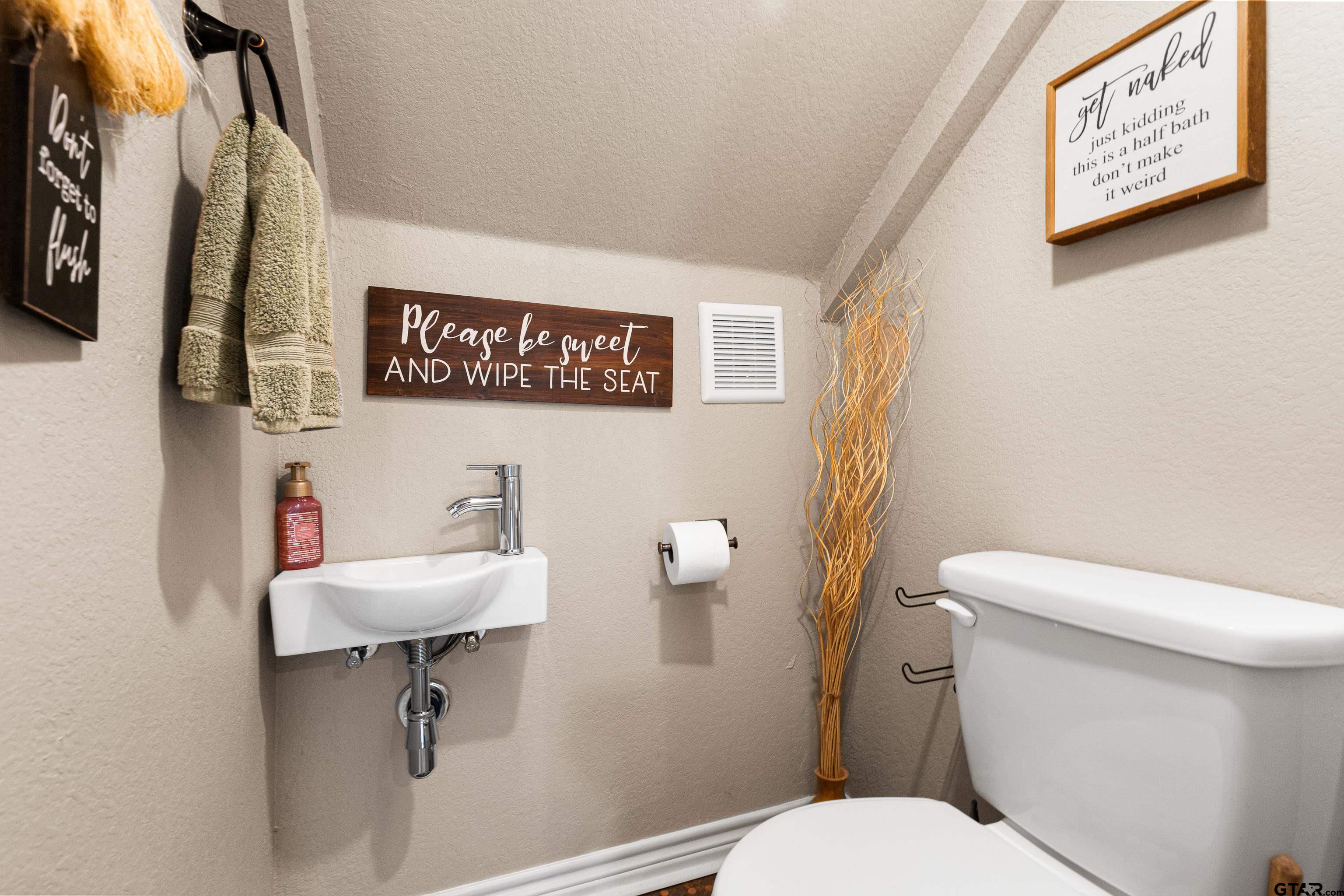 10586 Petunia Road Ore City, TX 75683 - Photo 36 of 45 a white toilet sitting next to a bathroom sink