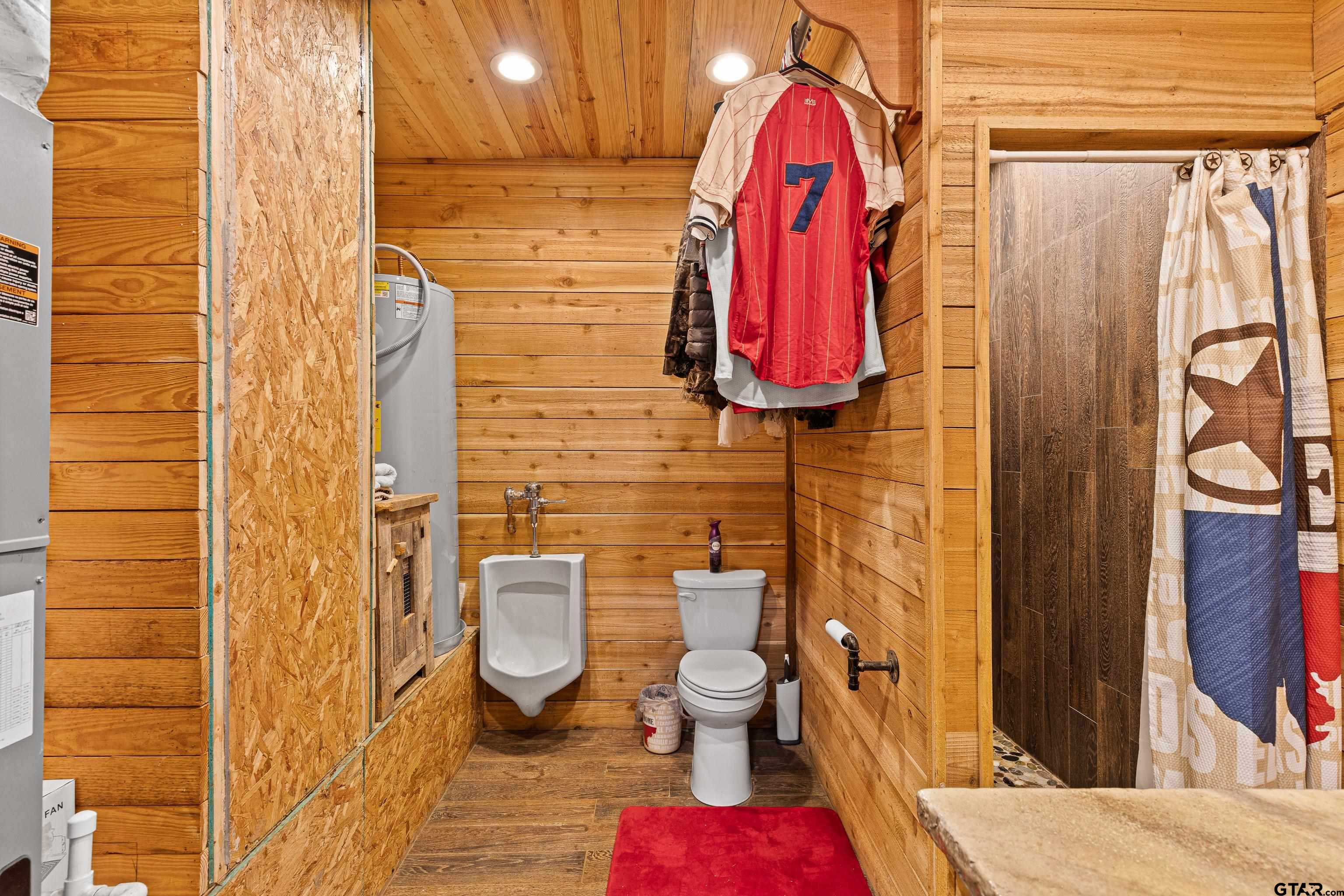10586 Petunia Road Ore City, TX 75683 - Photo 40 of 45 a bathroom with a toilet and shower