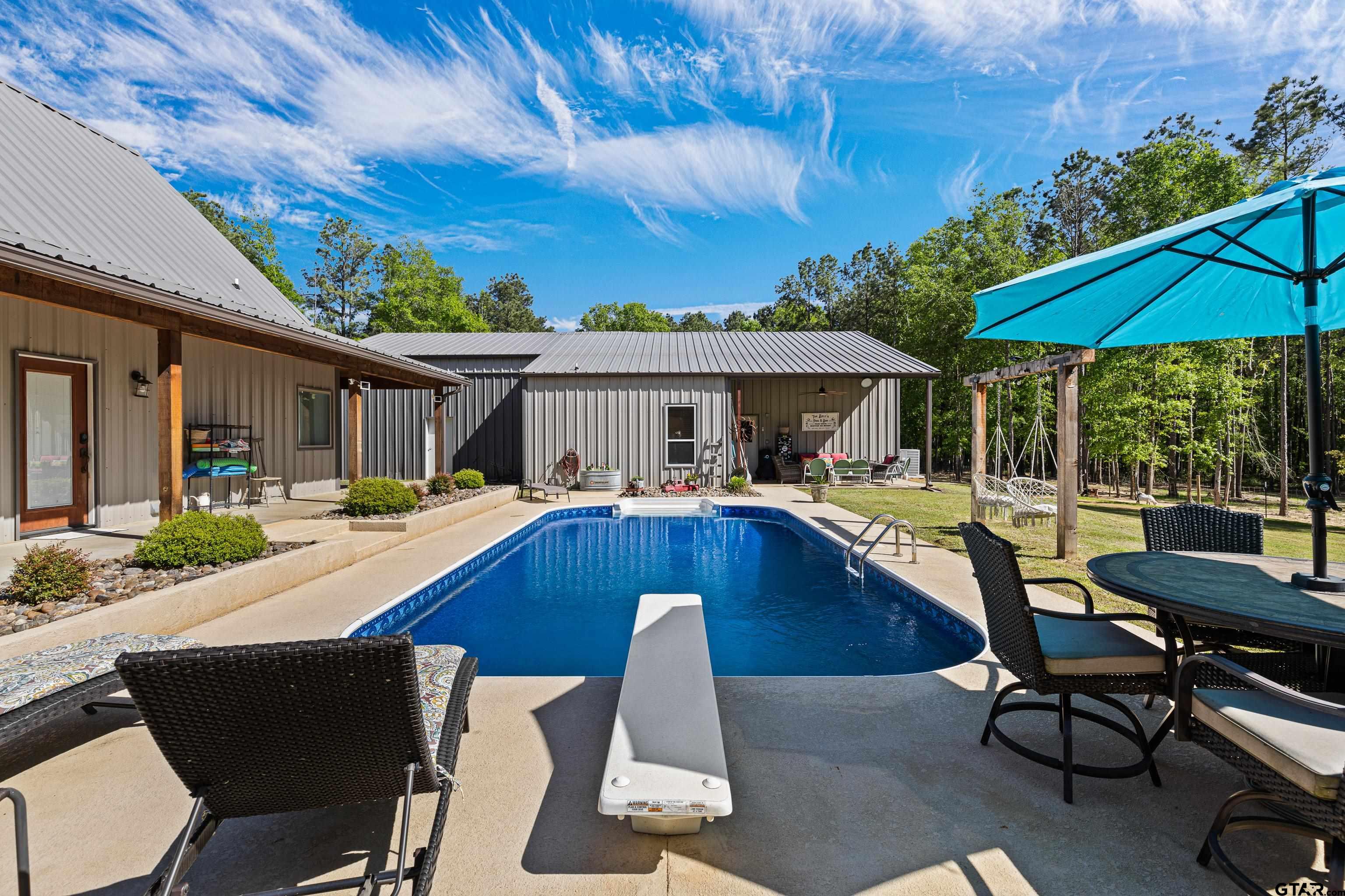 10586 Petunia Road Ore City, TX 75683 - Photo 4 of 45 a view of house with swimming pool outdoor seating area