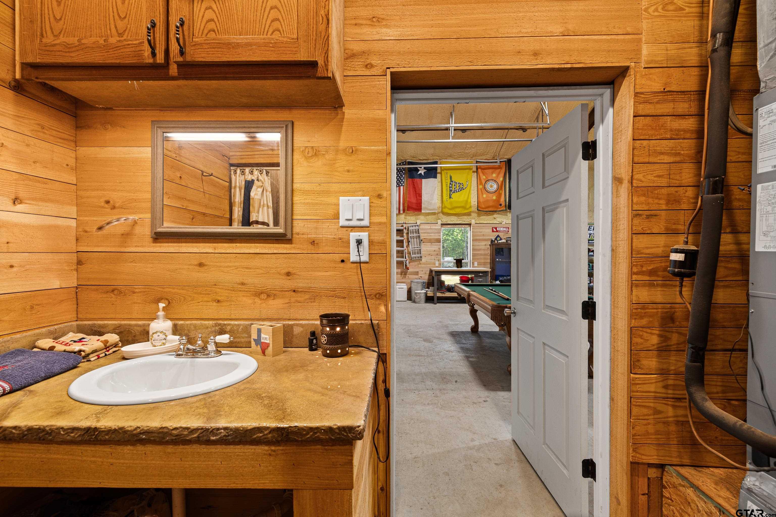 10586 Petunia Road Ore City, TX 75683 - Photo 41 of 45 a bathroom with a sink and a mirror