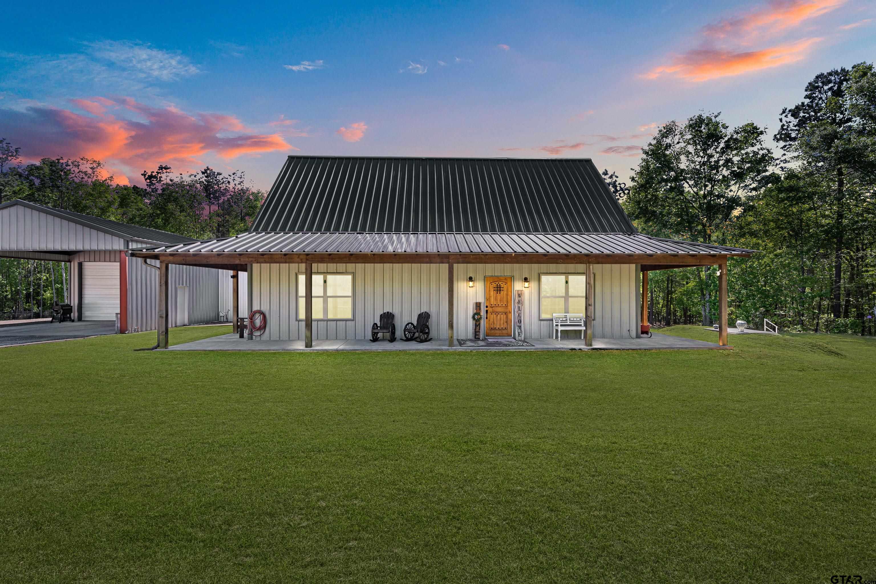 10586 Petunia Road Ore City, TX 75683 - Photo 5 of 45 a front view of a house with a garden