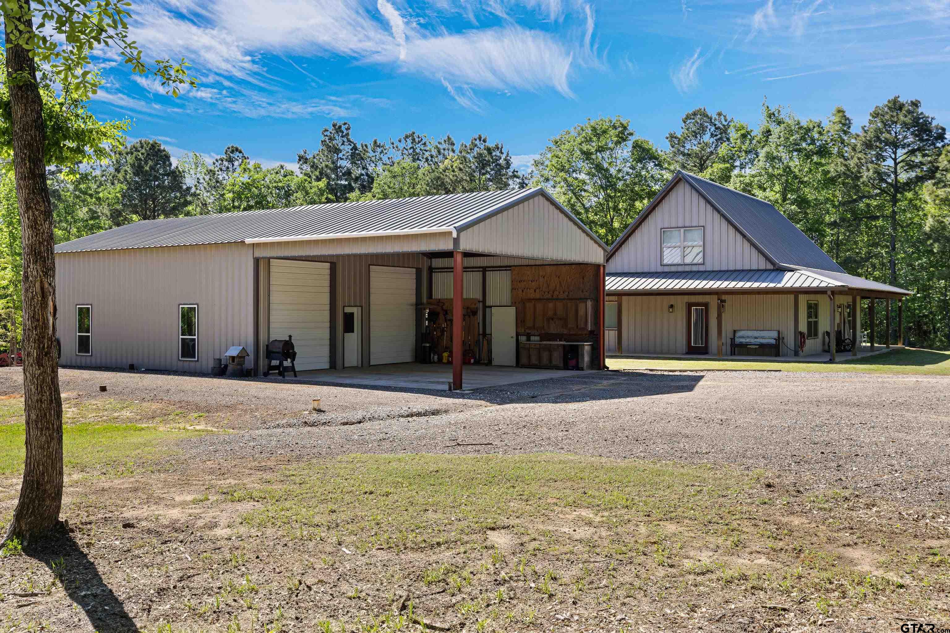 10586 Petunia Road Ore City, TX 75683 - Photo 6 of 45 a front view of a house with garden