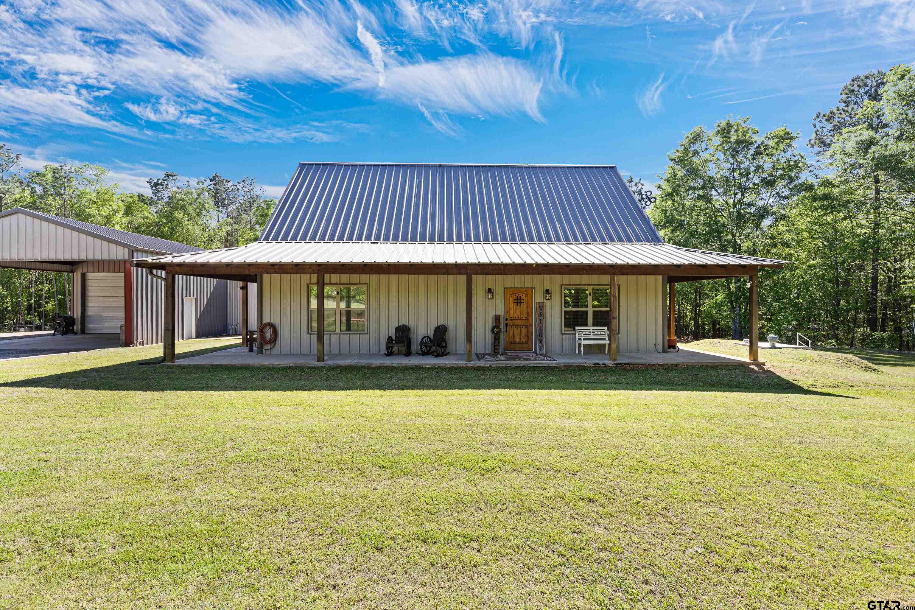 10586 Petunia Road Ore City, TX 75683 - Photo 7 of 45 a front view of a house with swimming pool having outdoor seating