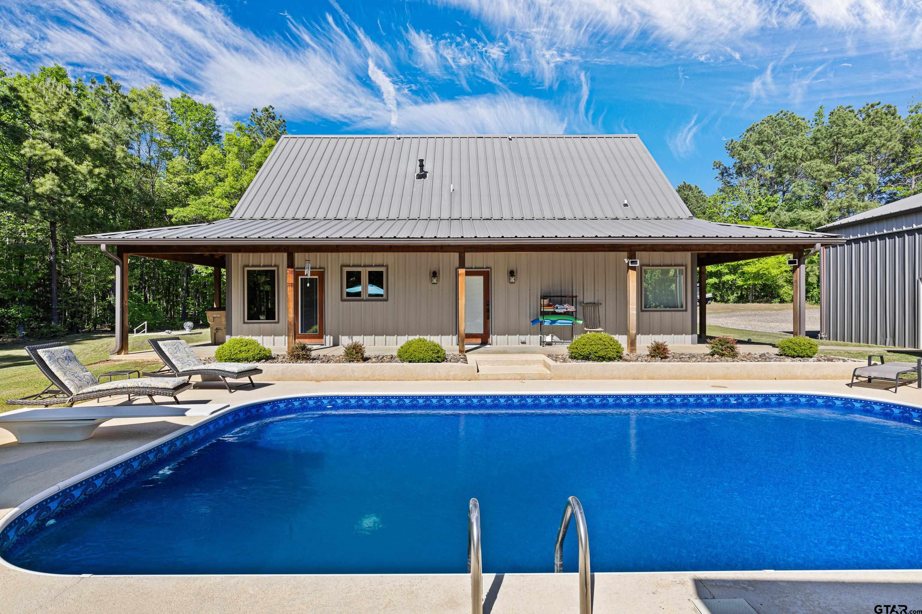10586 Petunia Road Ore City, TX 75683 - Photo 9 of 45 a view of swimming pool with outdoor seating