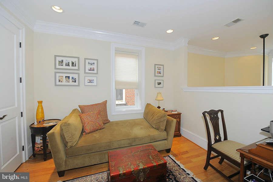 629 4th Street Northeast, Unit 3 Washington, DC 20002 - Photo 15 of 30 a bedroom with a bed and wooden floor