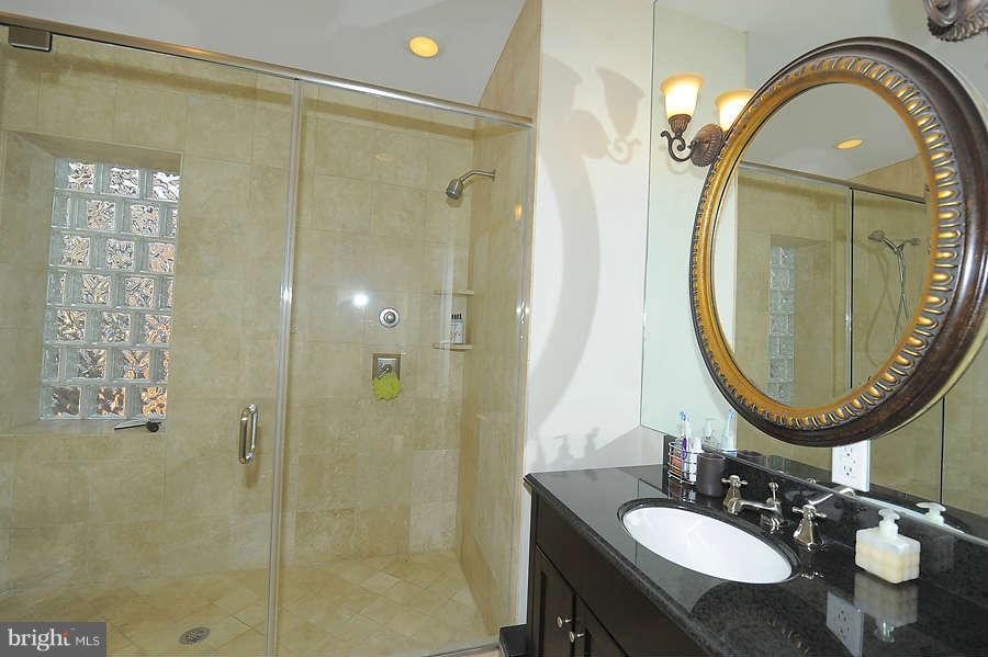 629 4th Street Northeast, Unit 3 Washington, DC 20002 - Photo 24 of 30 a bathroom with a sink and a mirror