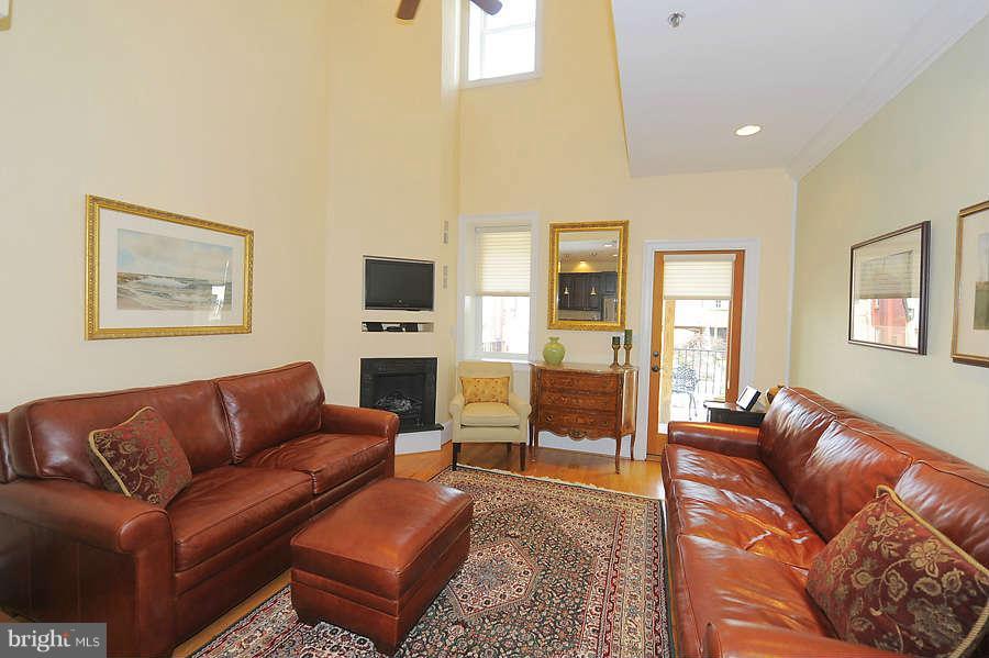 629 4th Street Northeast, Unit 3 Washington, DC 20002 - Photo 8 of 30 a living room with furniture a couch and two flat screen tv