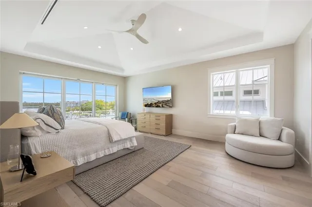 a spacious bedroom with a bed a couch and a window