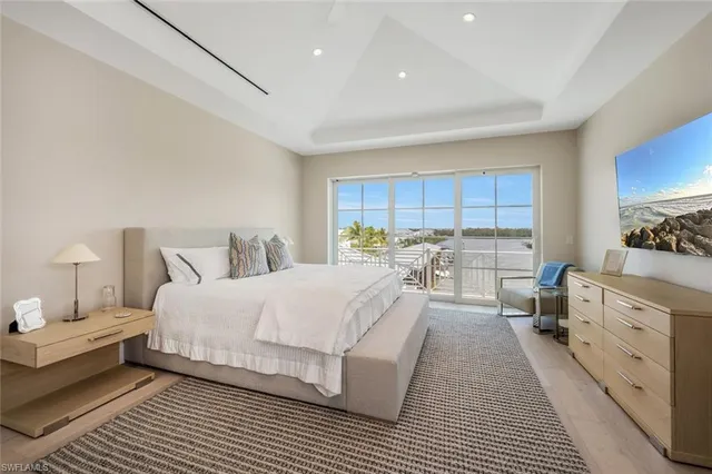 a bed room with a bed and a large window