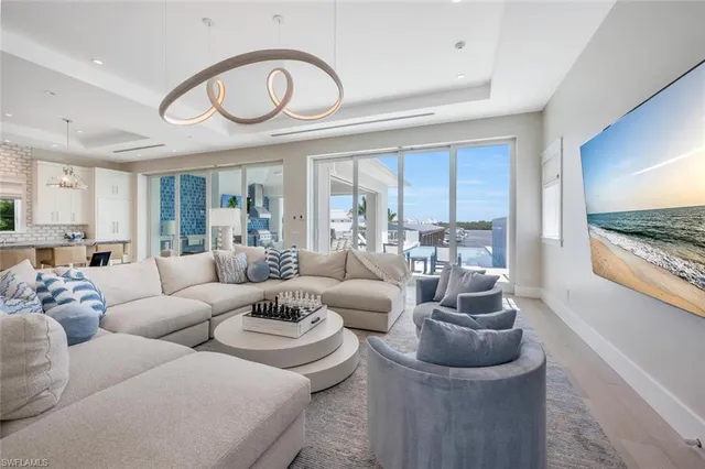 a living room with furniture a large window and a fireplace