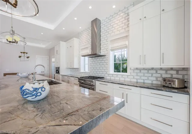 a kitchen with a sink a stove and cabinets