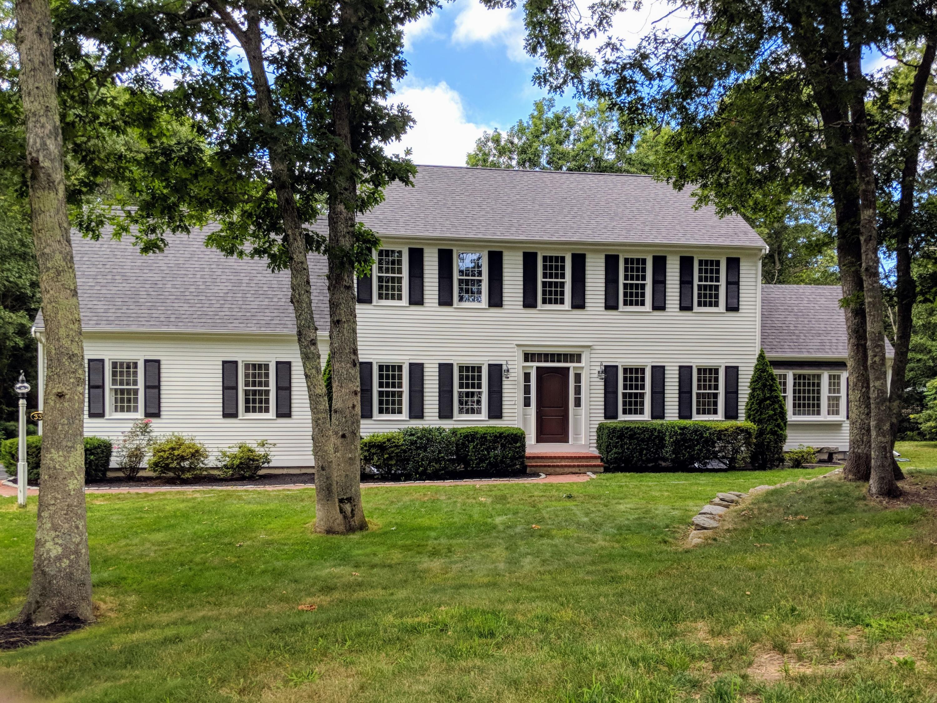 33 Highfield Drive Sandwich, MA 02563 - Photo 1 of 16 a front view of a house with a garden and trees