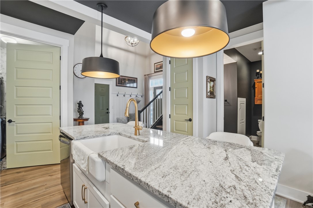 605 Cape Cod Court Beavercreek, OH 45430 - Photo 13 of 54 This modern kitchen features a spacious island with a farm sink and sleek pendant lighting.