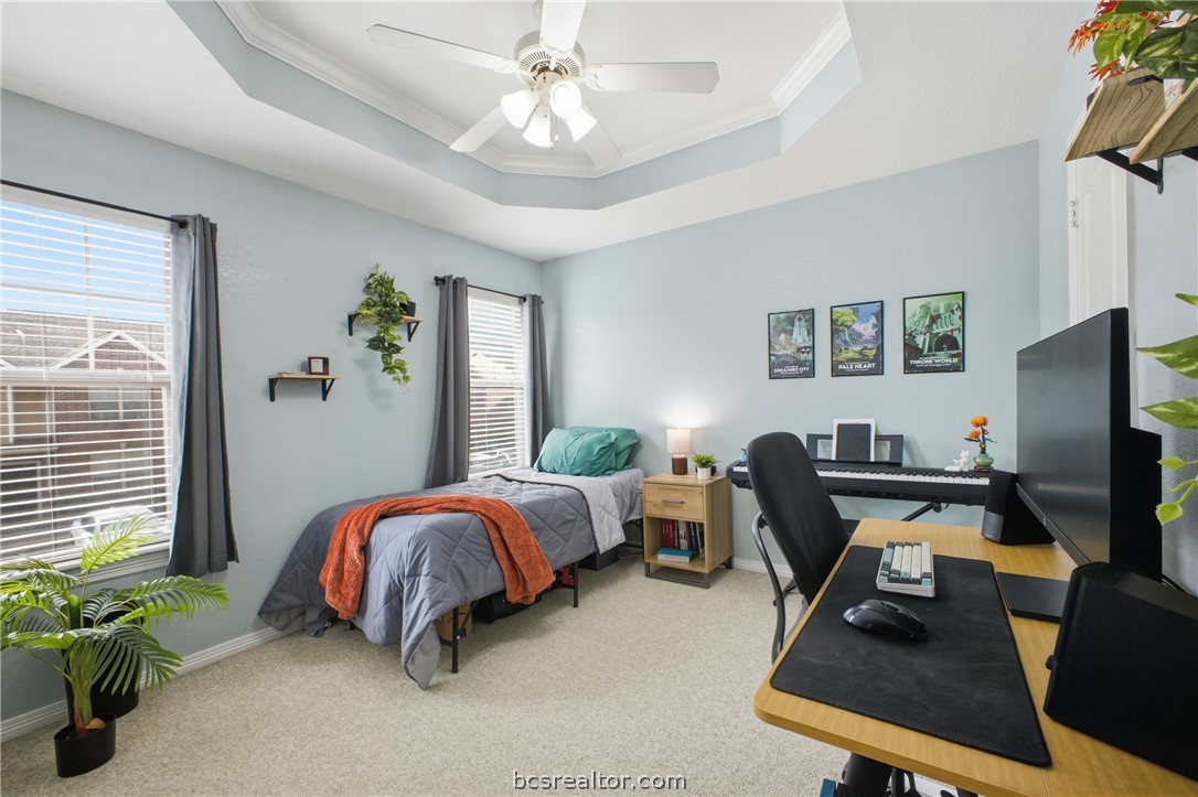 1000 Spring Loop, Unit 2105 College Station, TX 77840 - Photo 14 of 22 a bedroom with a bed and a desk