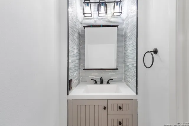 a bathroom with a sink and a mirror