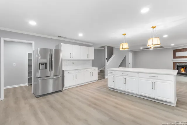 a kitchen with stainless steel appliances a refrigerator sink and cabinets