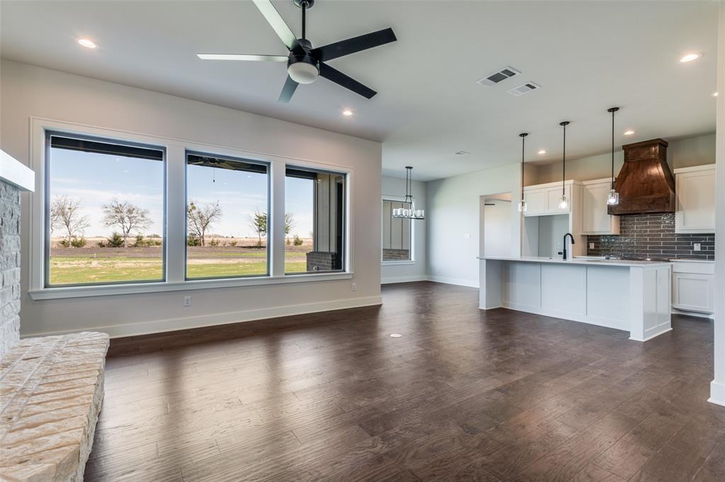 815 Evergreen Way Nevada, TX 75173 - Photo 13 of 38 a view of an empty room with window and wooden floor