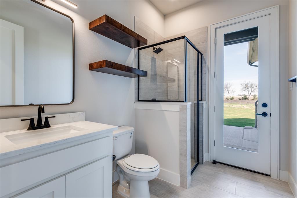 815 Evergreen Way Nevada, TX 75173 - Photo 15 of 38 a bathroom with a sink toilet and shower