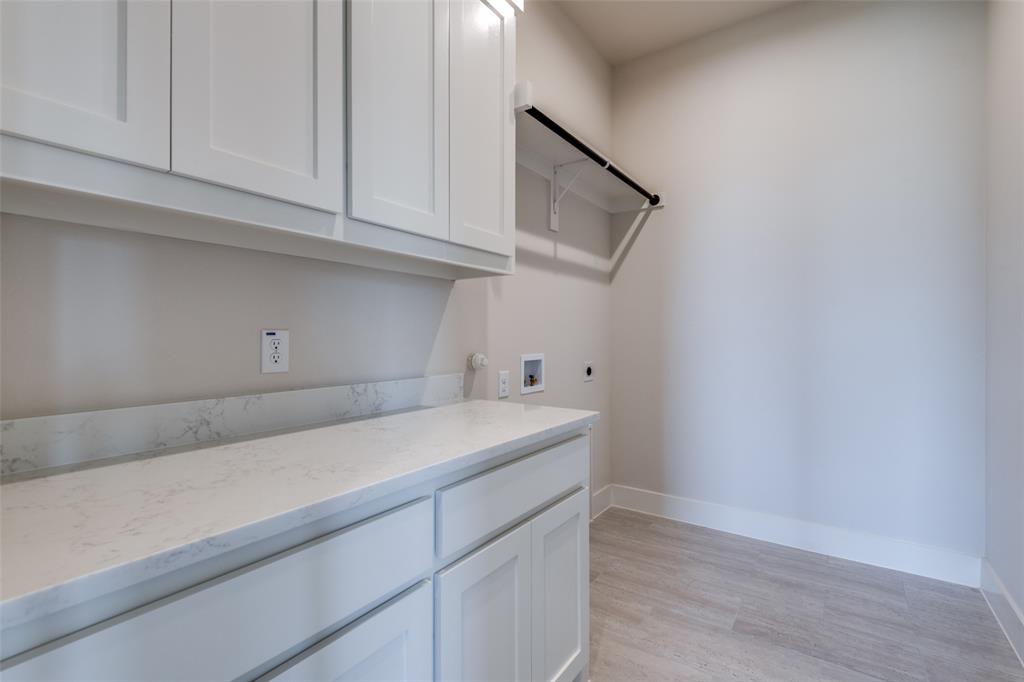 815 Evergreen Way Nevada, TX 75173 - Photo 18 of 38 a utility room with cabinets