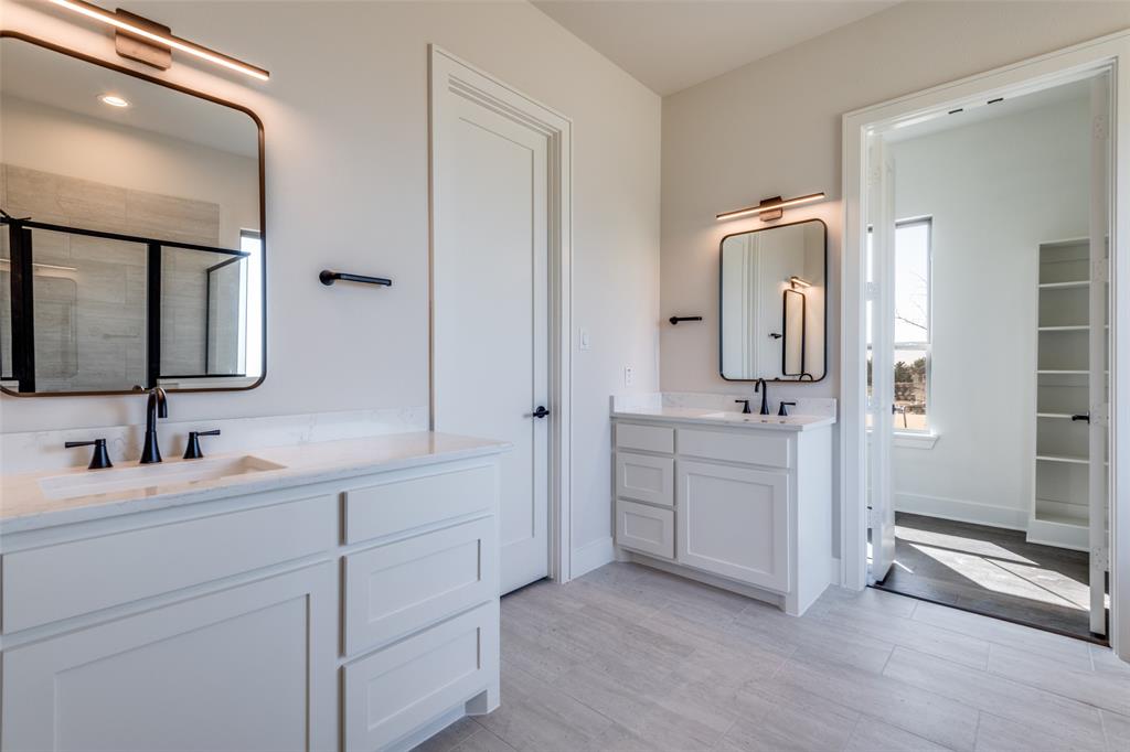 815 Evergreen Way Nevada, TX 75173 - Photo 22 of 38 a bathroom with a double vanity sink mirror and