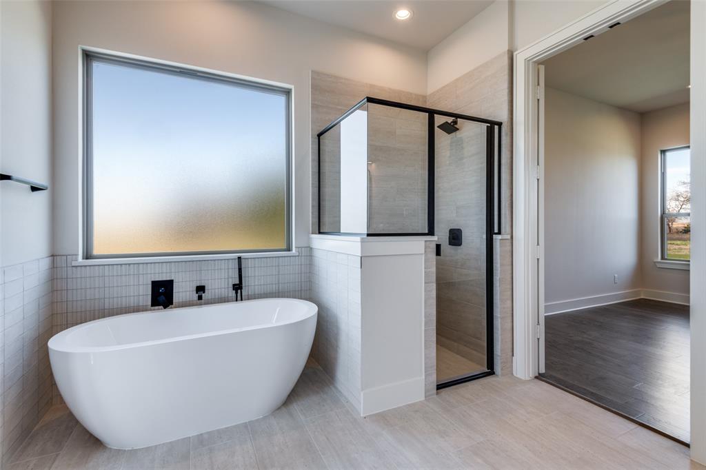815 Evergreen Way Nevada, TX 75173 - Photo 23 of 38 a bathroom with a white tub shower and sink