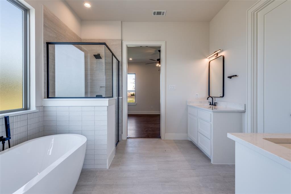 815 Evergreen Way Nevada, TX 75173 - Photo 24 of 38 a bathroom with a tub sink and mirror