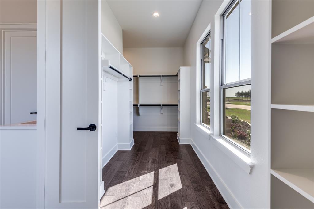 815 Evergreen Way Nevada, TX 75173 - Photo 26 of 38 a view of a hallway with wooden floor and windows